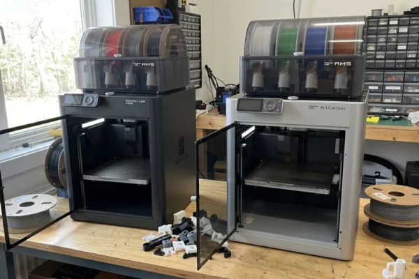 Bambu P2S and X1C printers side by side on a desk
